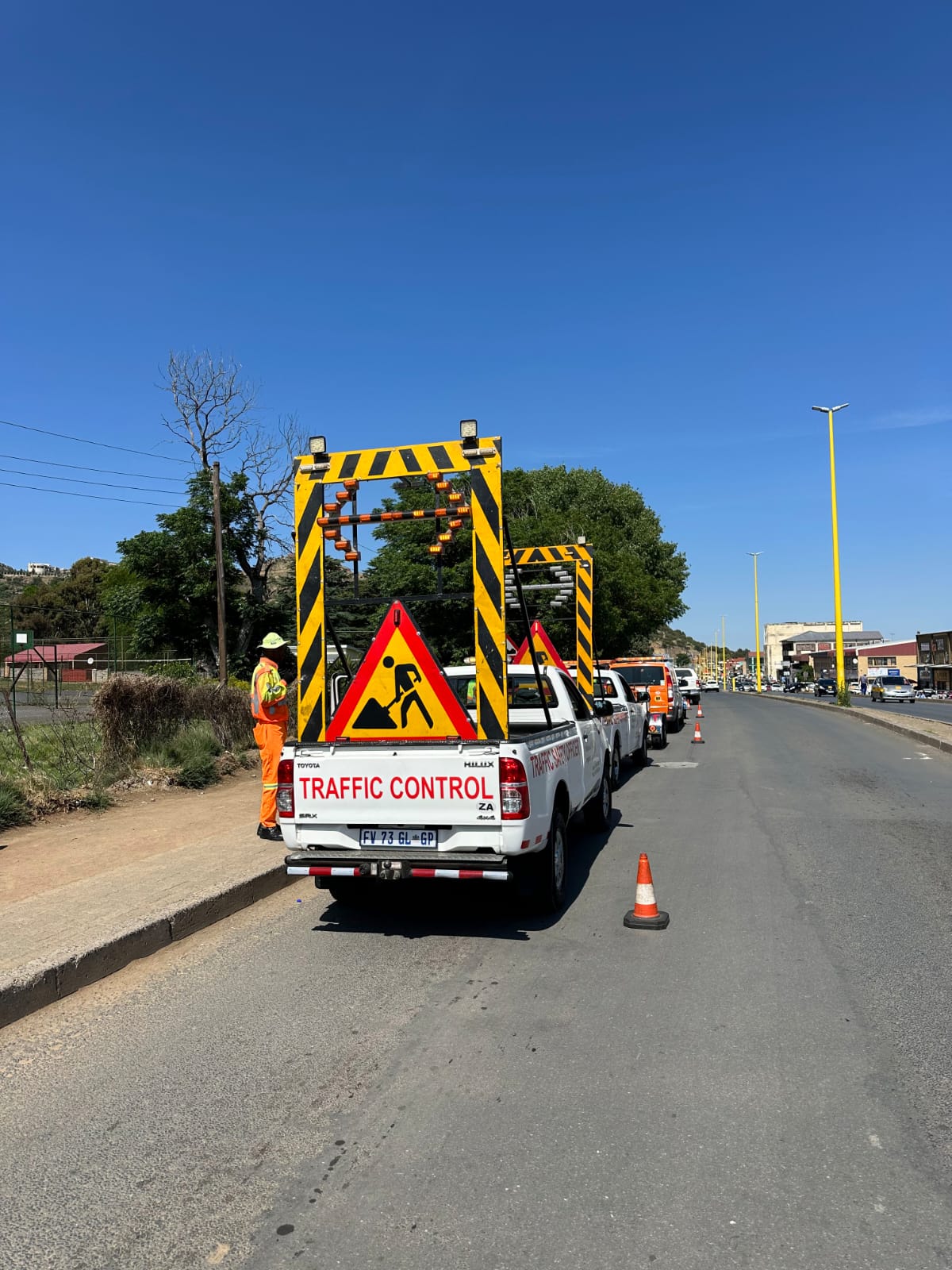 Traffic control vehicle with warning signage on an urban road